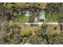 Aerial view of property showing home, sheds, and surrounding trees at 6706 16Th E Ave, Palmetto, FL 34221