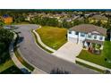 Two-story home with a neatly manicured lawn, a two-car garage, and a view of the neighborhood at 7404 Mill Hopper Ct, Palmetto, FL 34221