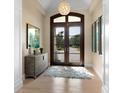 Bright and airy foyer with hardwood floors, a large rug, and double doors at 8325 Lindrick Ln, Bradenton, FL 34202