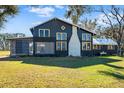 Renovated farmhouse showcasing a unique architectural style and landscaping at 14900 Coker Gully Rd, Myakka City, FL 34251
