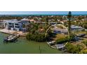 Waterfront property showcasing a private dock on a scenic canal with ocean access and tropical landscaping at 15815 Redington Dr, Redington Beach, FL 33708