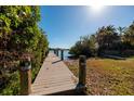 Private wooden dock leading to the water at 15815 Redington Dr, Redington Beach, FL 33708