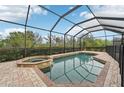 Screened pool and spa with brick pavers at 20345 Reale Cir, Venice, FL 34293