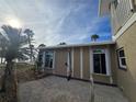 Tan house exterior with white trim, windows, and shutters at 215 Bahia Vista, Englewood, FL 34223