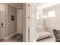 Bright entryway featuring white doors, neutral walls, and tile flooring, leading to a cozy interior at 2479 Brassica Dr, North Port, FL 34289