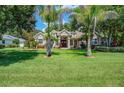 Luxury home with palm trees and a spacious green lawn at 3706 162Nd E Ave, Parrish, FL 34219