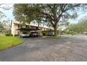 Condo building exterior, showing multiple units and parking at 380 Three Lakes Ln # L, Venice, FL 34285