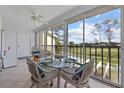 Sunroom with glass doors, view of the golf course, and wicker furniture at 414 Cerromar S Cir # 249, Venice, FL 34293