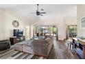 Open living area with sectional sofa, hardwood floors, and sliding glass doors at 4498 Diamond E Cir, Sarasota, FL 34233