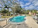 Community pool with surrounding patio furniture and landscaping at 5026 Water Oak Dr # 105, Bradenton, FL 34207