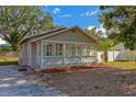 Quaint house with a screened porch and gravel driveway at 5121 22Nd Street E Ct, Bradenton, FL 34203