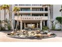 Elegant building entrance with water feature, welcoming residents and guests at 5300 Ocean Blvd # 704, Sarasota, FL 34242