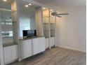 Built-in entertainment center and gray vinyl flooring at 5947 Benevento Dr, Sarasota, FL 34238