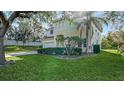 Two-story house with light-colored exterior, landscaping, and a fenced backyard at 6963 74Th Street E Cir, Bradenton, FL 34203