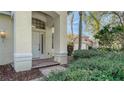 Front entrance with a white door, brick walkway, and landscaping at 6963 74Th Street E Cir, Bradenton, FL 34203