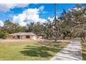 One-story home with a long driveway and lush landscaping at 7321 Proctor Rd, Sarasota, FL 34241