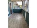 The screened patio has a wood-look floor, painted railings and door to the left at 4802 51St W St # 1406, Bradenton, FL 34210