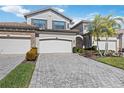 Two-story home with three-car garage and paver driveway at 5830 Wake Forest Run # 102, Bradenton, FL 34211