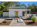 Modern home with yellow door, landscaped yard, and a sleek design at 603 38Th W St, Bradenton, FL 34205