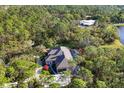 Stunning aerial view of home, pool, and lush wooded surroundings at 6700 S Gator Creek Blvd, Sarasota, FL 34241