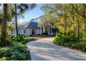 Beautiful home with a long driveway and mature landscaping at 6700 S Gator Creek Blvd, Sarasota, FL 34241