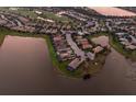 Aerial view of a residential neighborhood with golf course, several homes with pools are arranged around a scenic lake at 7115 Callander Cv, Lakewood Ranch, FL 34202
