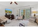 Bright living room with comfortable seating and access to balcony at 7325 Black Walnut Way, Lakewood Ranch, FL 34202
