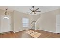 Light and airy living room with hardwood floors and a staircase at 7664 Plantation Cir, Bradenton, FL 34201