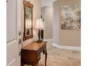 Elegant entryway with a wooden console table, mirror, and lamp at 7840 34Th W Ave # 203, Bradenton, FL 34209