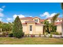 Inviting two-story townhome with a red tile roof, lush lawn, and well-maintained landscaping at 9623 Sea Turtle Ter # 201, Bradenton, FL 34212