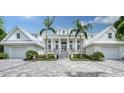 Two-story home with white exterior and gray driveway at 178 N Washington Dr, Sarasota, FL 34236