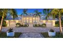 Elegant home with white exterior, landscaping and lighting at 178 N Washington Dr, Sarasota, FL 34236