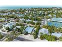 Aerial view showcasing home's location near tennis courts and ocean at 312 Hardin Ave, Anna Maria, FL 34216