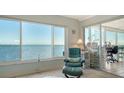 Relaxing sunroom with water views, comfortable seating and workspace at 4800 Gulf Of Mexico Dr # Ph 3, Longboat Key, FL 34228