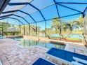 Relaxing pool area with screened enclosure and lake view at 4867 Sabal Lake Cir, Sarasota, FL 34238