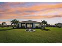 Spacious backyard with lush lawn and patio seating area at 5060 Lake Overlook Ave, Bradenton, FL 34208