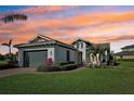 Charming one-story home with lush lawn, brick driveway, manicured landscaping and a two-car garage at 5060 Lake Overlook Ave, Bradenton, FL 34208