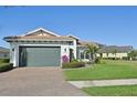 Charming one-story home with lush lawn, brick driveway, manicured landscaping and a two-car garage at 5060 Lake Overlook Ave, Bradenton, FL 34208