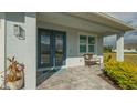 Front porch with double doors, a bench, and potted plants at 5252 Willow Lake Ct, Sarasota, FL 34233