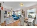 Bright living room with hardwood floors, comfy seating, and a dining area at 585 Purdy St, Englewood, FL 34223