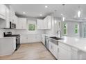 This kitchen has white cabinets, stainless appliances, and a large undermount sink at 6005 Mesa Gln, Bradenton, FL 34203