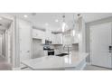 Bright kitchen with a spacious island, stainless steel appliances, and stylish pendant lighting at 6107 Mesa Gln, Bradenton, FL 34203