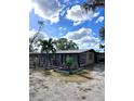 Ranch style home with metal roof and mature landscaping at 6504 Lincoln Rd, Bradenton, FL 34203