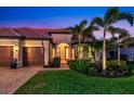 Beautiful home exterior at dusk with landscaping at 19864 Petrino St, Venice, FL 34293