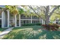 Two-story building with lush landscaping and a tree at 3745 Almeria Ave # 3S, Sarasota, FL 34239