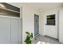 Bright condo entry featuring a white door and gray security door at 4330 Falmouth Dr # 108, Longboat Key, FL 34228