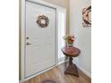 Bright entryway with decorative wreath and side table at 4504 Cinnamon Dr # 2308, Sarasota, FL 34238