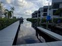 View of canal with wooden docks and boats at 515 Leffingwell Ave # 109, Ellenton, FL 34222