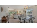 Bright dining area with glass table and seating for four at 5242 Wedgewood Ln # 62, Sarasota, FL 34235