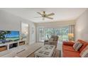 Living room with comfortable seating and access to balcony at 5242 Wedgewood Ln # 62, Sarasota, FL 34235